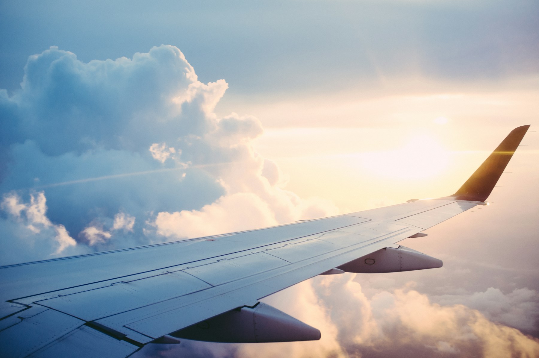Luxury airplane above clouds at golden hour